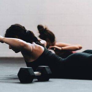 women doing a dumbbell workout with a friend wearing black